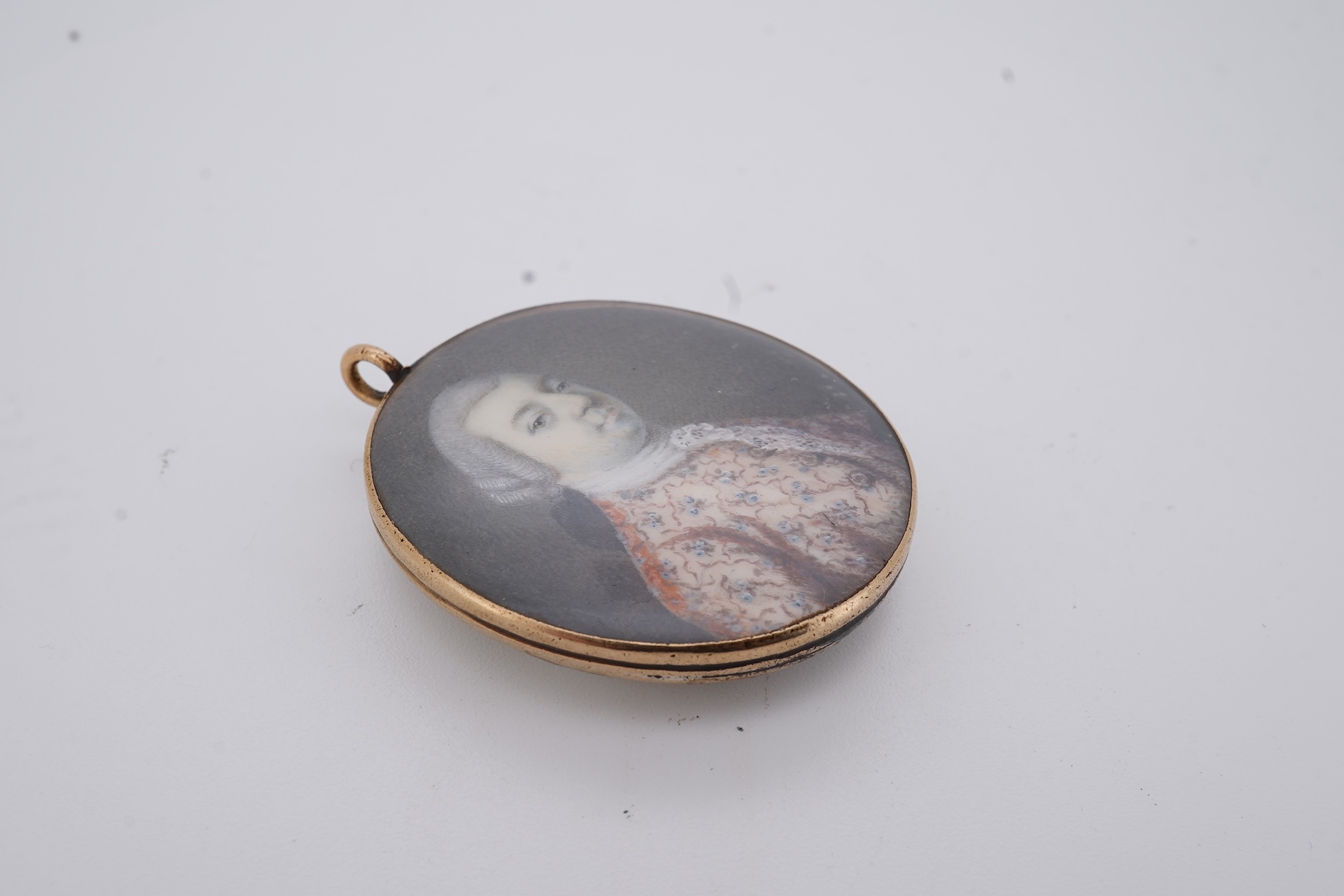 A 19th century gilt framed oval miniature watercolour portrait of a gentleman, on ivory, verso decorated with hair, depicting a landscape scene with a large tree, animals and a house, 36mm. CITES Submission reference, WU